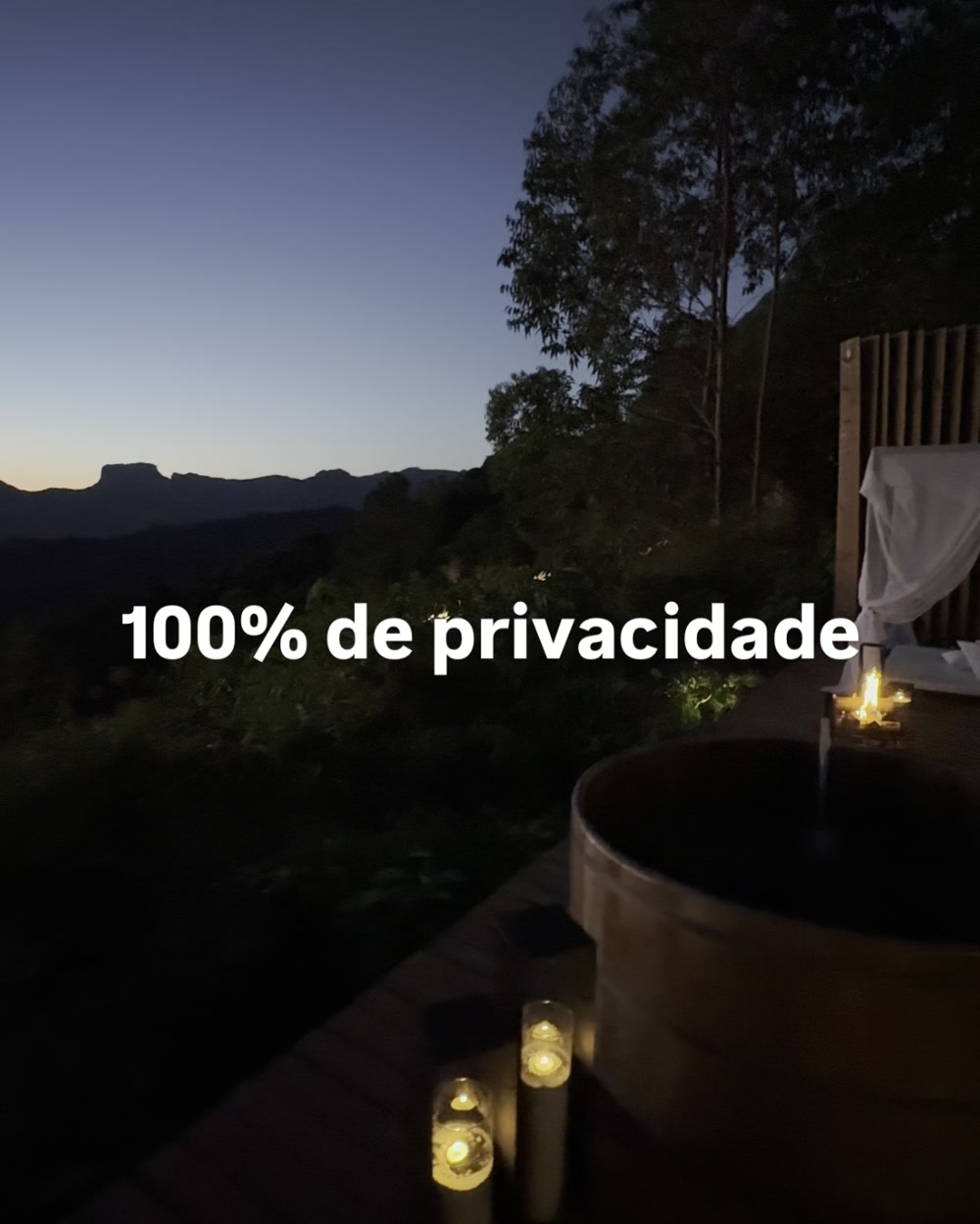 Ofurô no deck ao entardecer, com a serra ao fundo